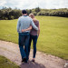 A documentary style photograph of a couple walking during their engagement session