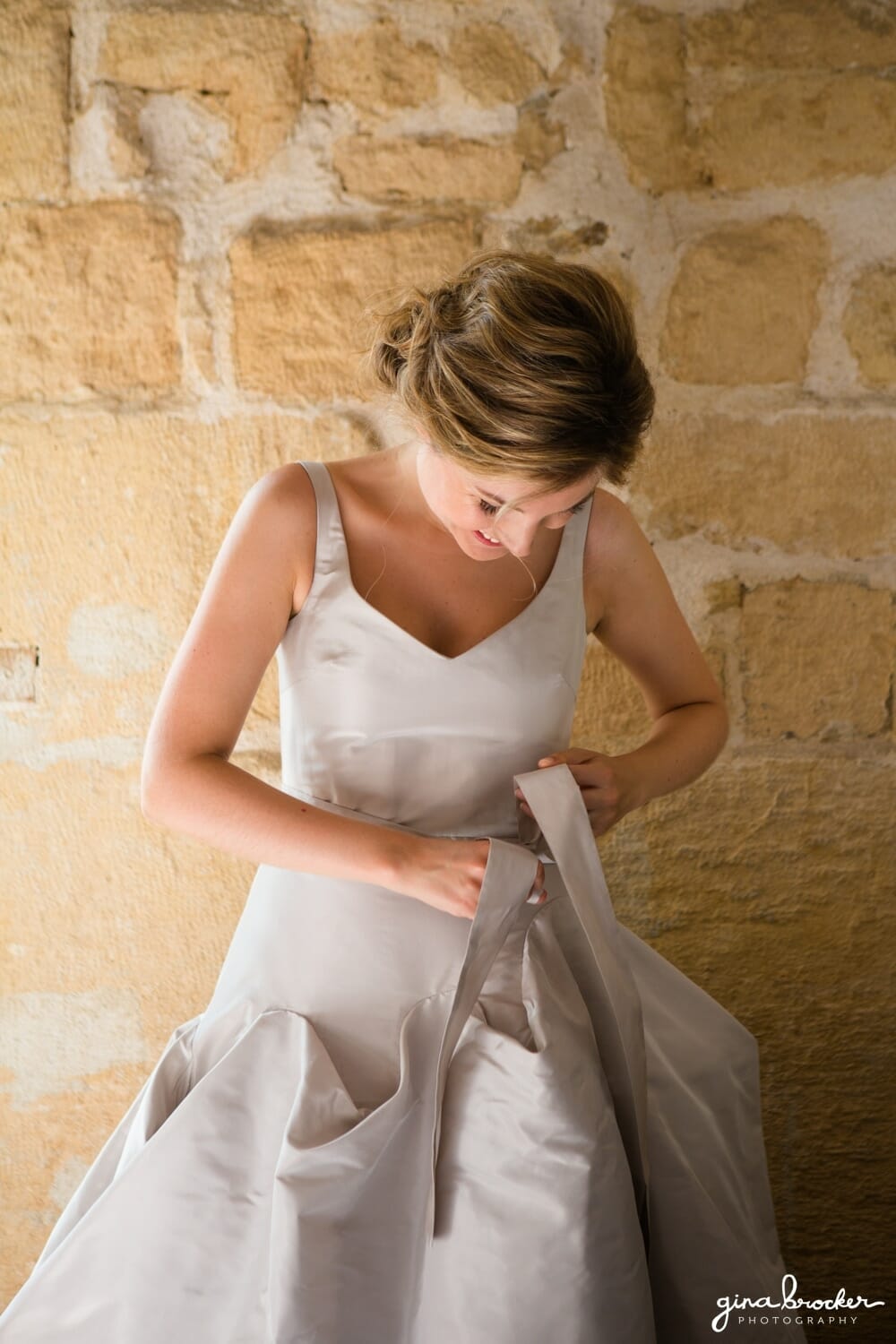 Bride fastens her French Wedding Dress