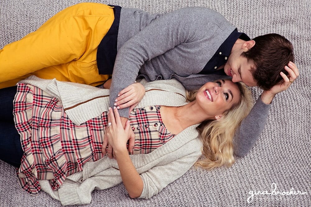 A couple lay together on a blanket during their sweet couple session in new england