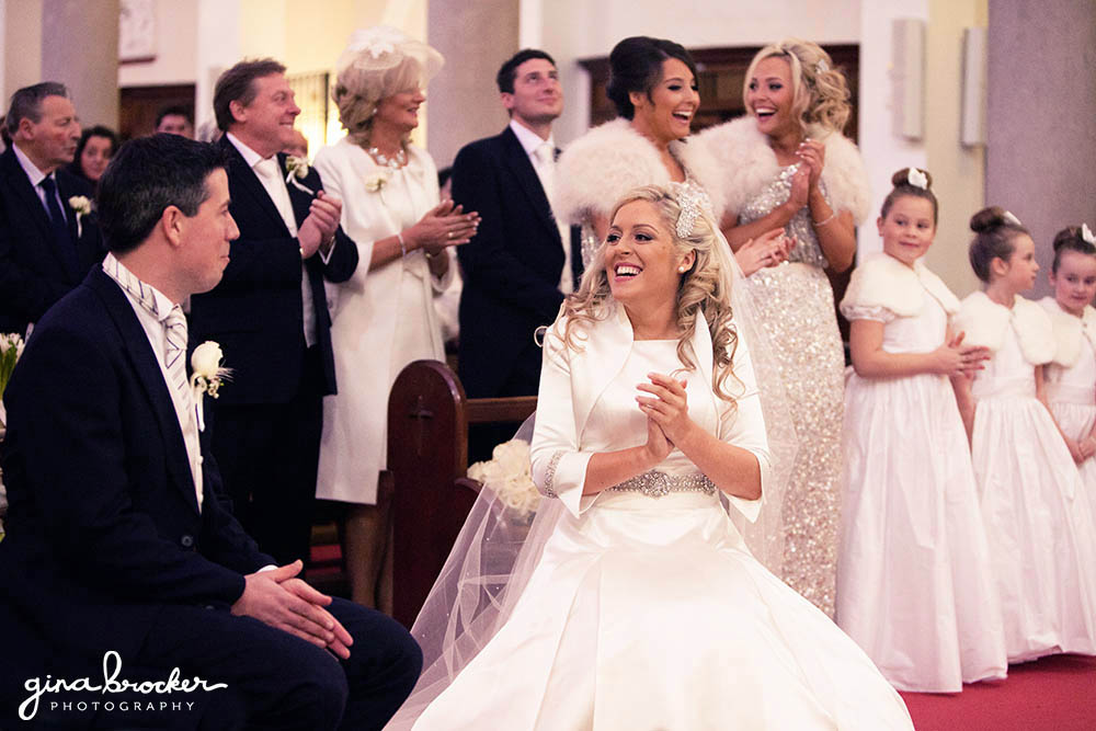 Bride, Groom and guest clap to the gospel choir during the classic winter wedding ceremony