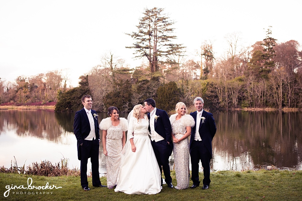 Classic winter wedding party wearing spakle silver dress and fur beside the lake
