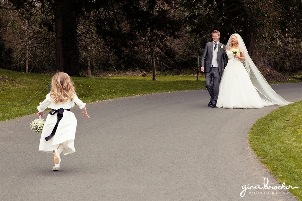 bride and groom walking with daughter 
