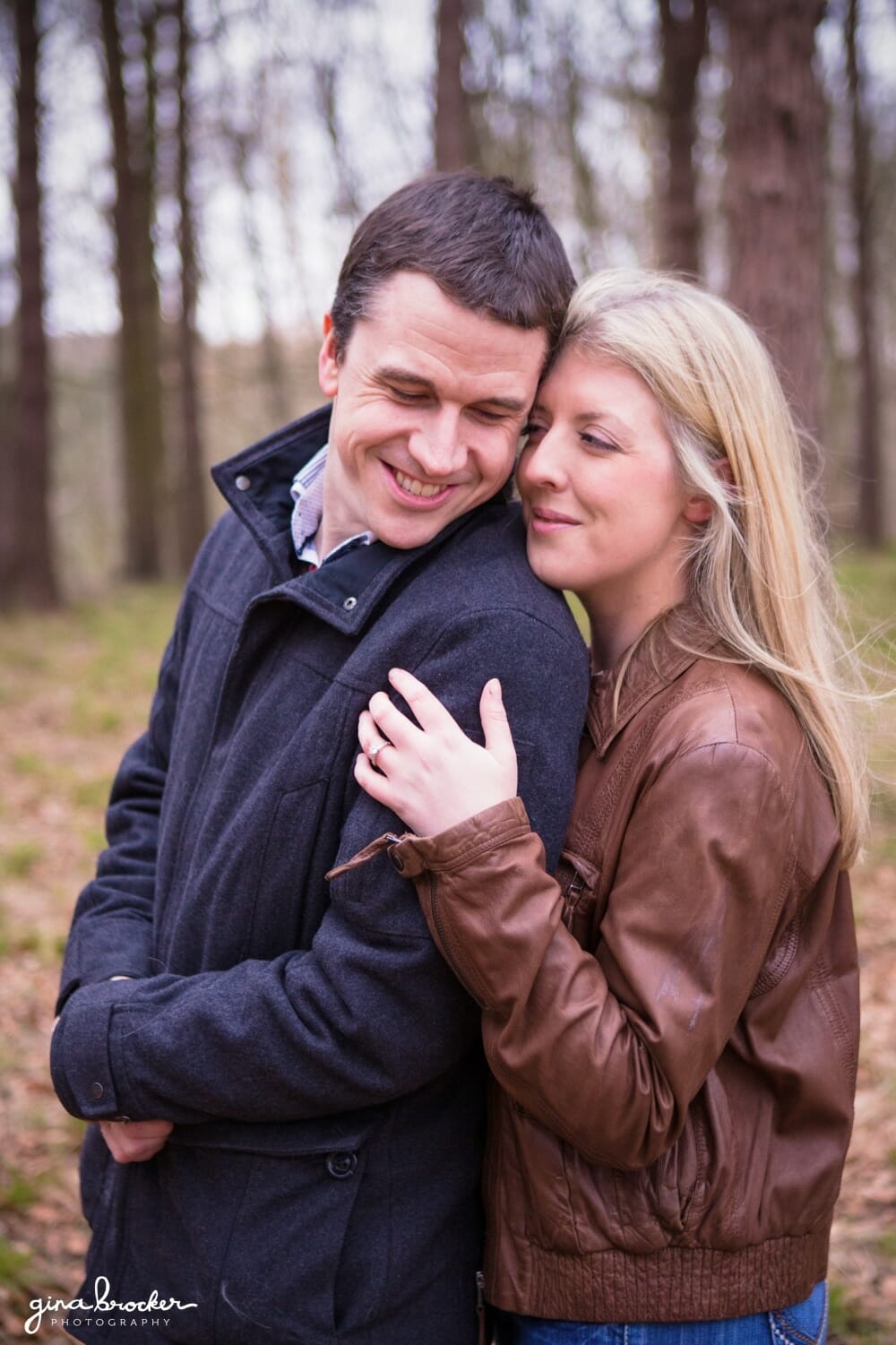 A sweet photograph of couple cuddling during their Boston Engagement Session in Arnold Arboretum
