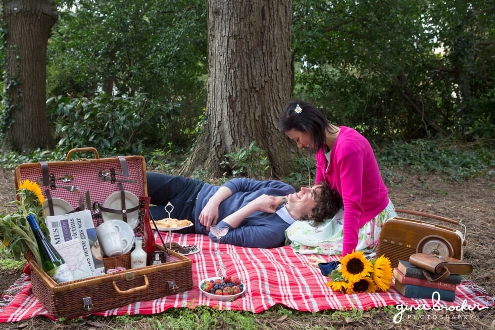 Husband laying with his wife during a picnic love shoot in the park
