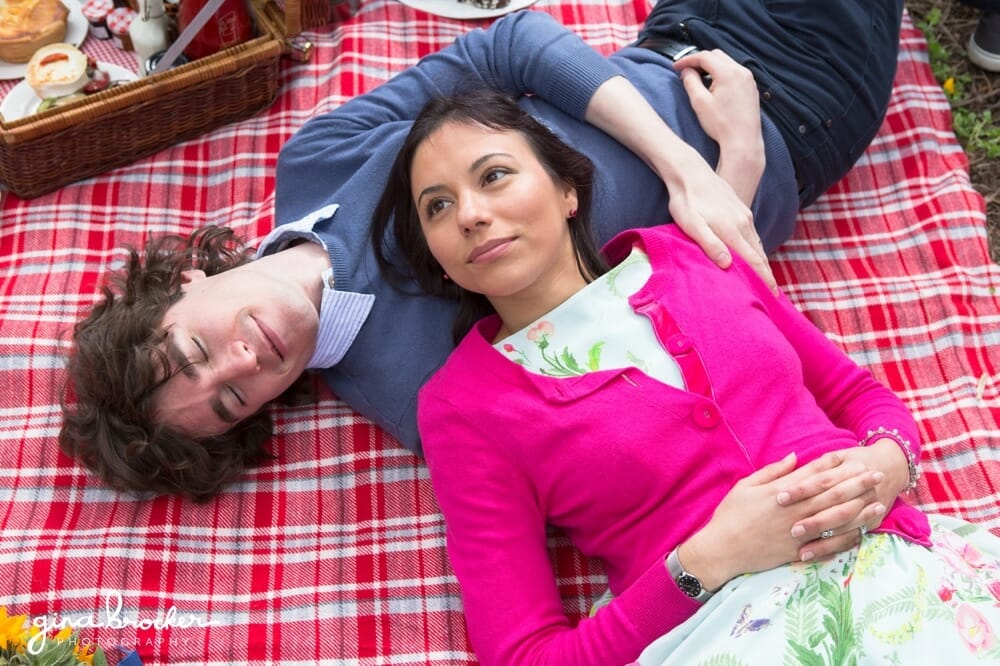 Couple lay on blanket during relaxed love story session in Boston