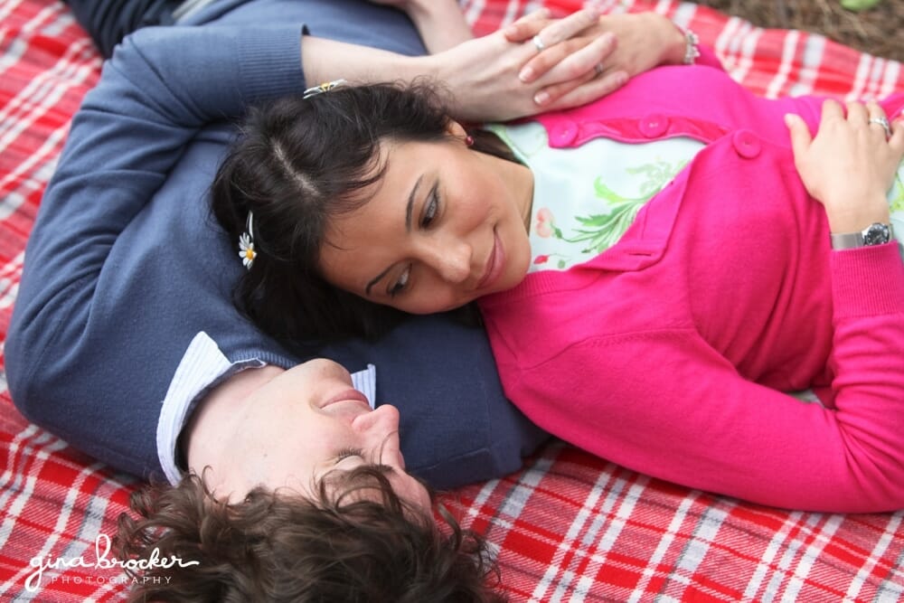 couple laying on blanket during a picnic love shoot