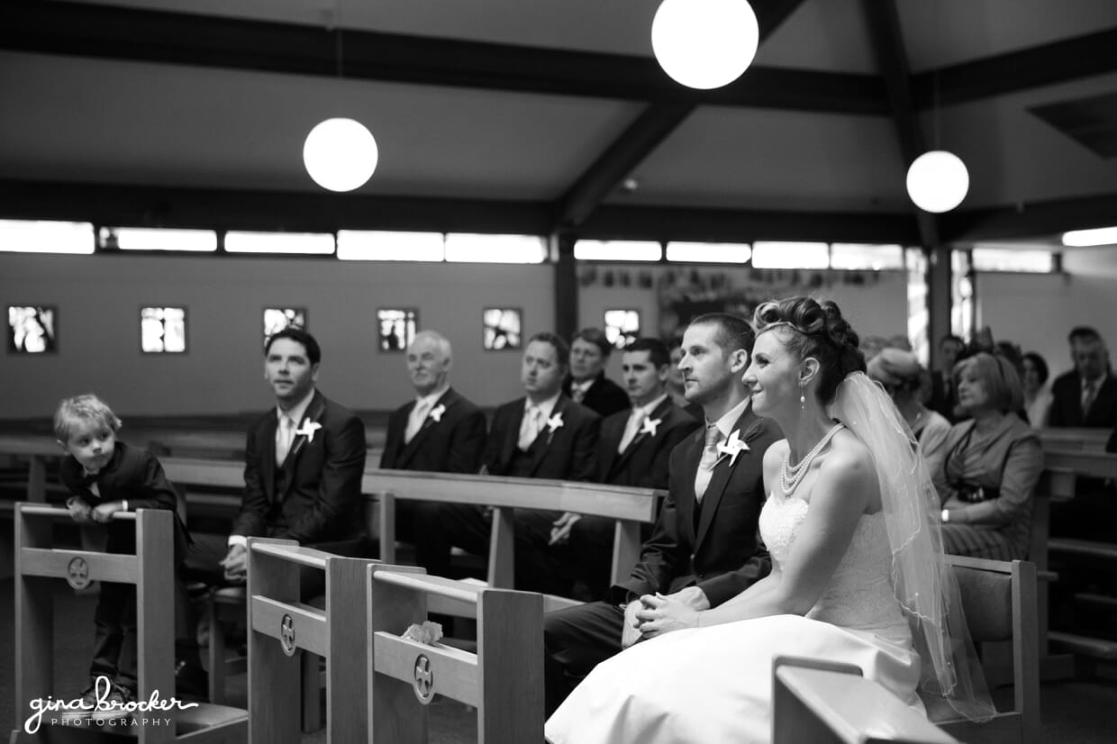 The ring bearer watches the bride and groom during their wedding ceremony