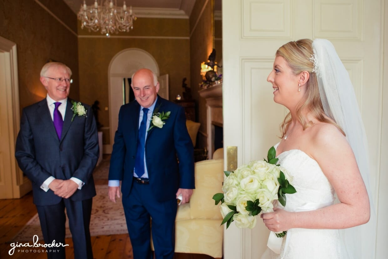 The father of the bride smiles when he sees his beautiful daughter as a bride