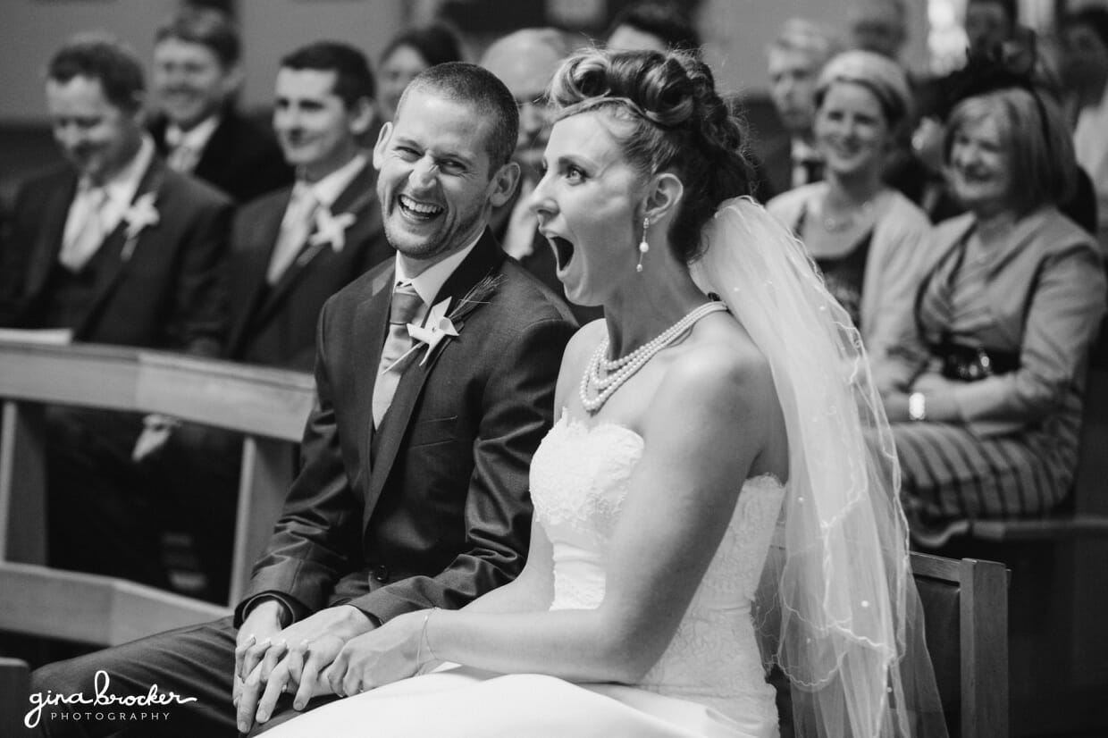 The bride and groom share a fun moment during their wedding ceremony