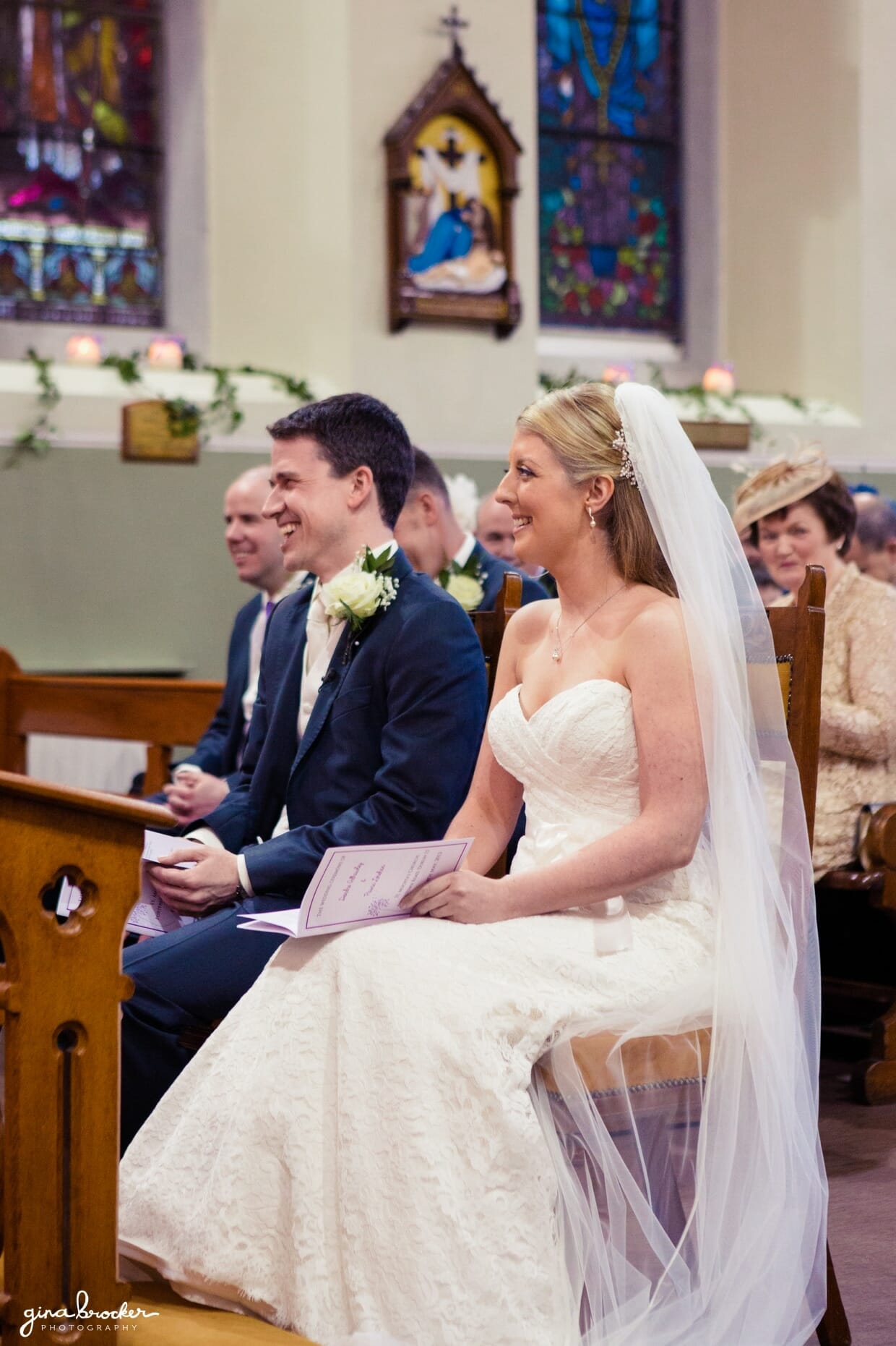The bride and groom share a funny moment during their intimate church wedding