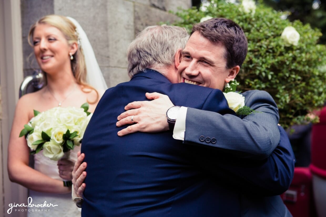 The groom hugs his guests during the reception line following their intimate wedding ceremony