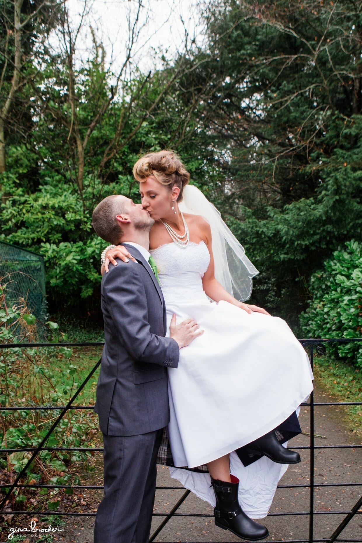 A sweet kiss between a bride and groom at their retro wedding