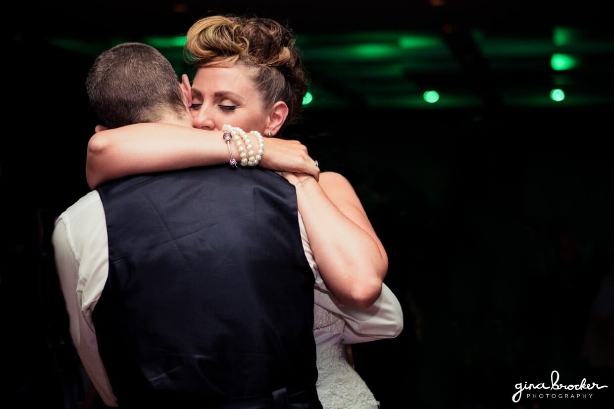 A sweet photograph of a bride and groom hugging during their first dance at their wedding in Boston, Massachusetts
