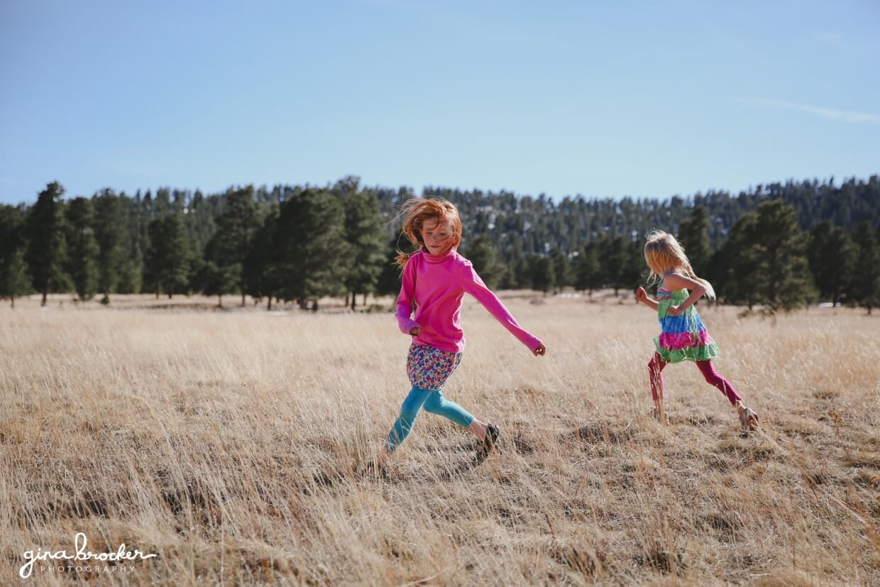 Kids play in a field during an outdoor photo session