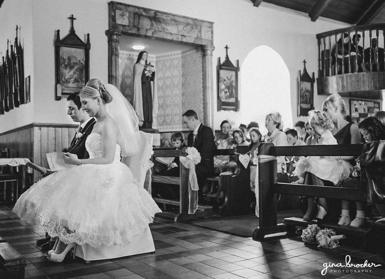 The bride and groom sit together during an intimate church wedding ceremony