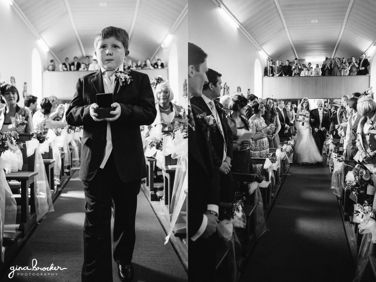 The ring bearer and the bride walk up the aisle of a small church during an intimate religious wedding ceremony