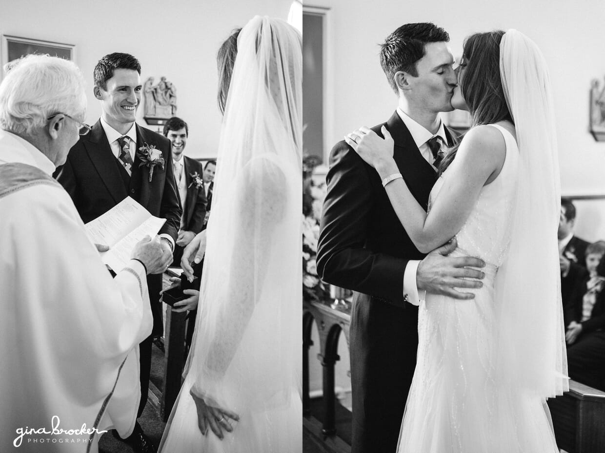 The bride and groom share their first kiss as husband and wife during their intimate wedding ceremony in a small church