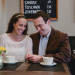 A couple share a sweet moment in a Beacon Hill Cafe during their anniversary photography session