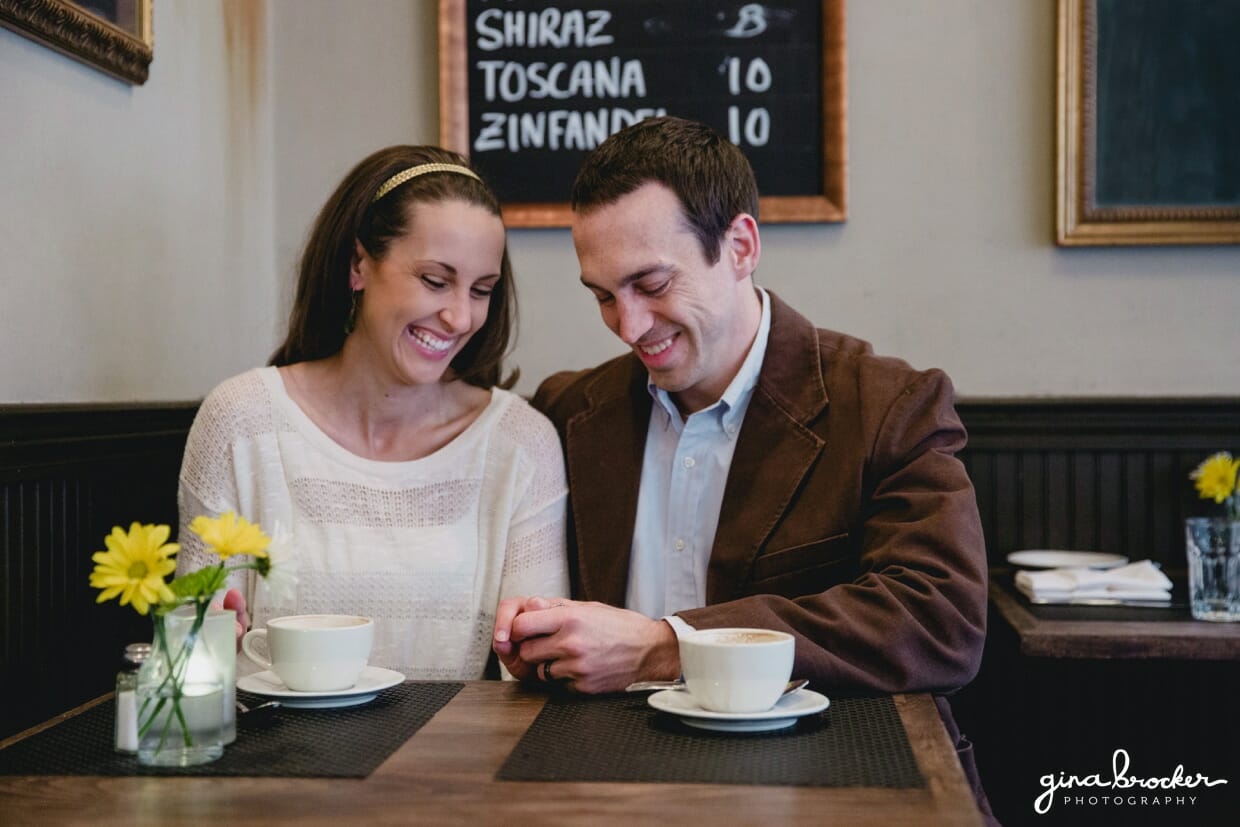 A couple share a sweet moment in panicifico cafe, boston, during their anniversary session in beacon hill