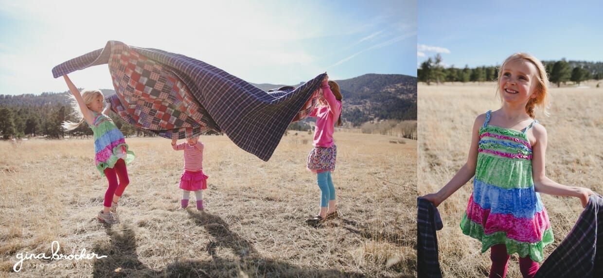 Girls have fun laying a blanket on the ground during their fun family photo shoot
