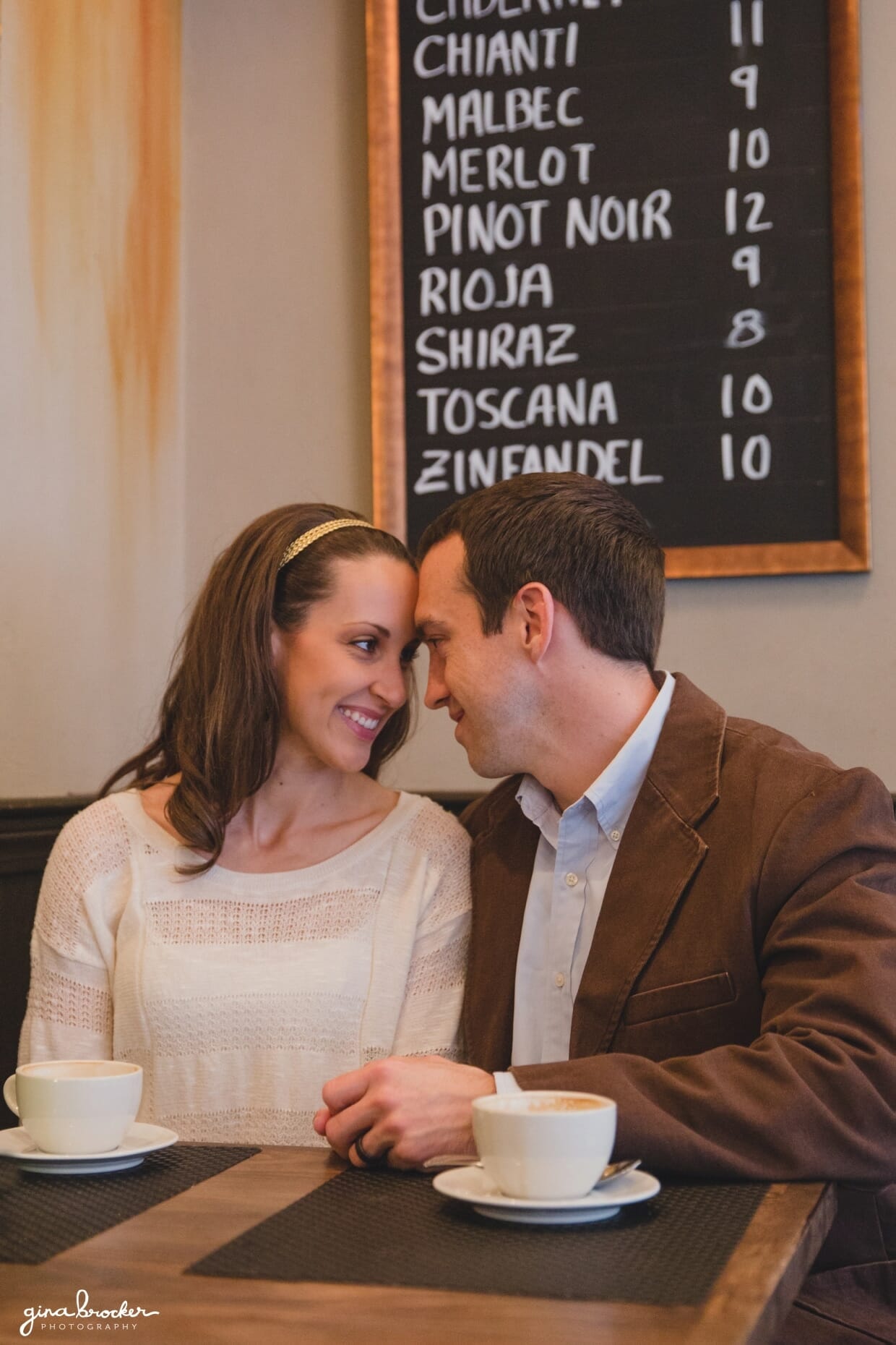 A couple look into each others eyes during a sweet and relaxed beacon hill couple session in a boston cafe