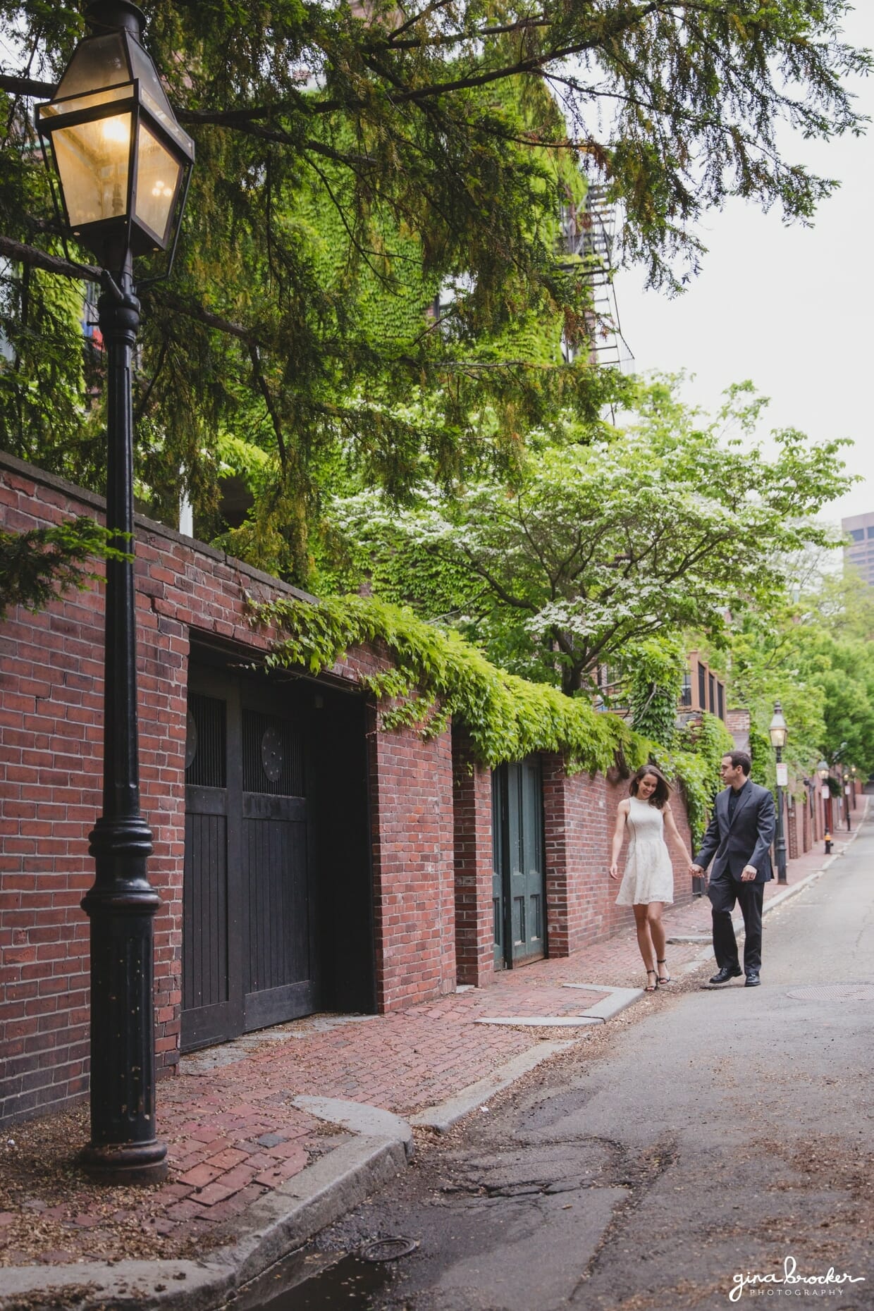A couple walk down the streets of Beacon Hill during a sweet Boston engagement session