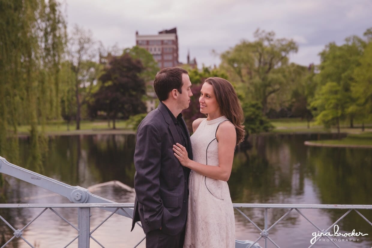 A couple share an intimate moment on the bridge of the Boston Public Gardens during their sweet engagement session