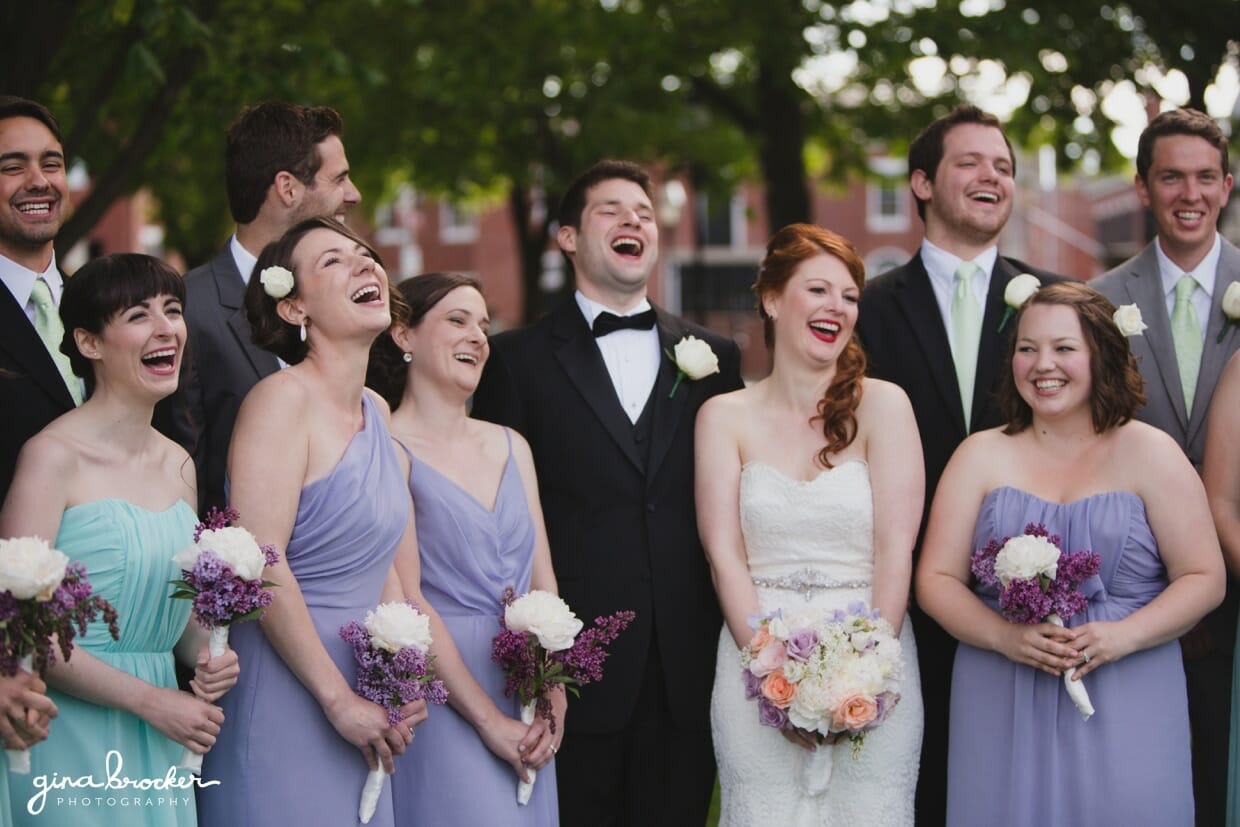 A fun and candid wedding portrait of a wedding party wearing aqua and lavender in Salem Common