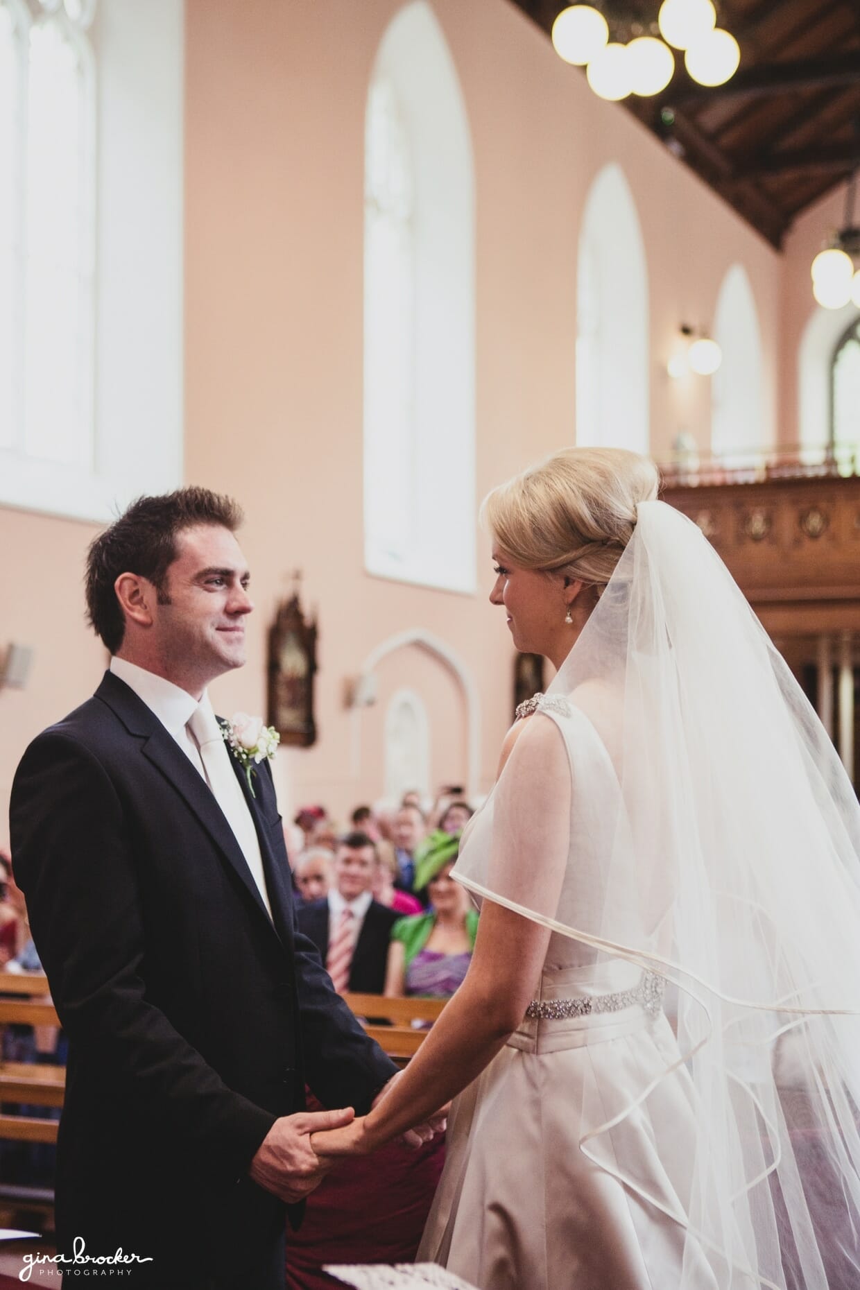 The bride and groom say their wedding vows during their religious ceremony in a church