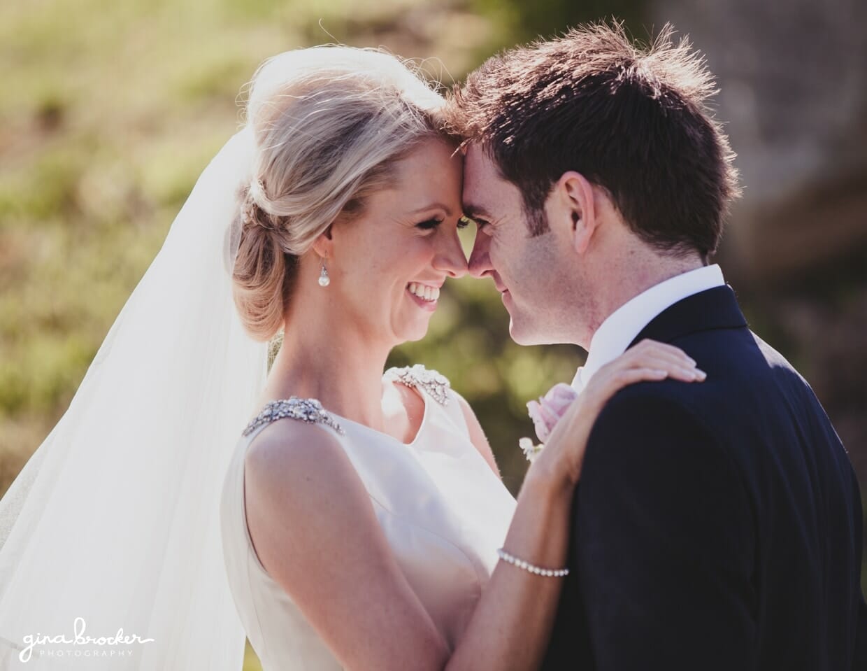A cute portrait of a bride and groom touching noses during their garden inspired wedding in Massachusetts