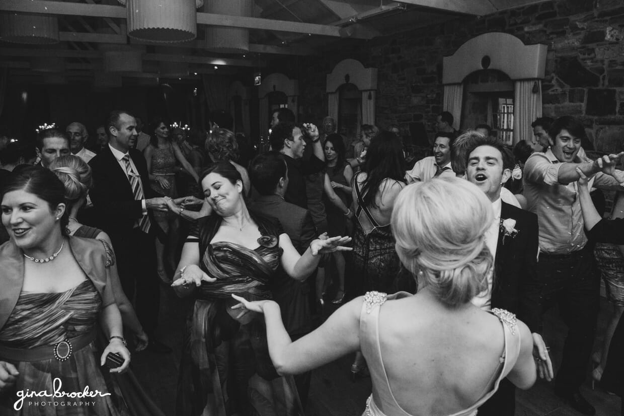 The bride and groom dance with their guest during their classic garden wedding reception