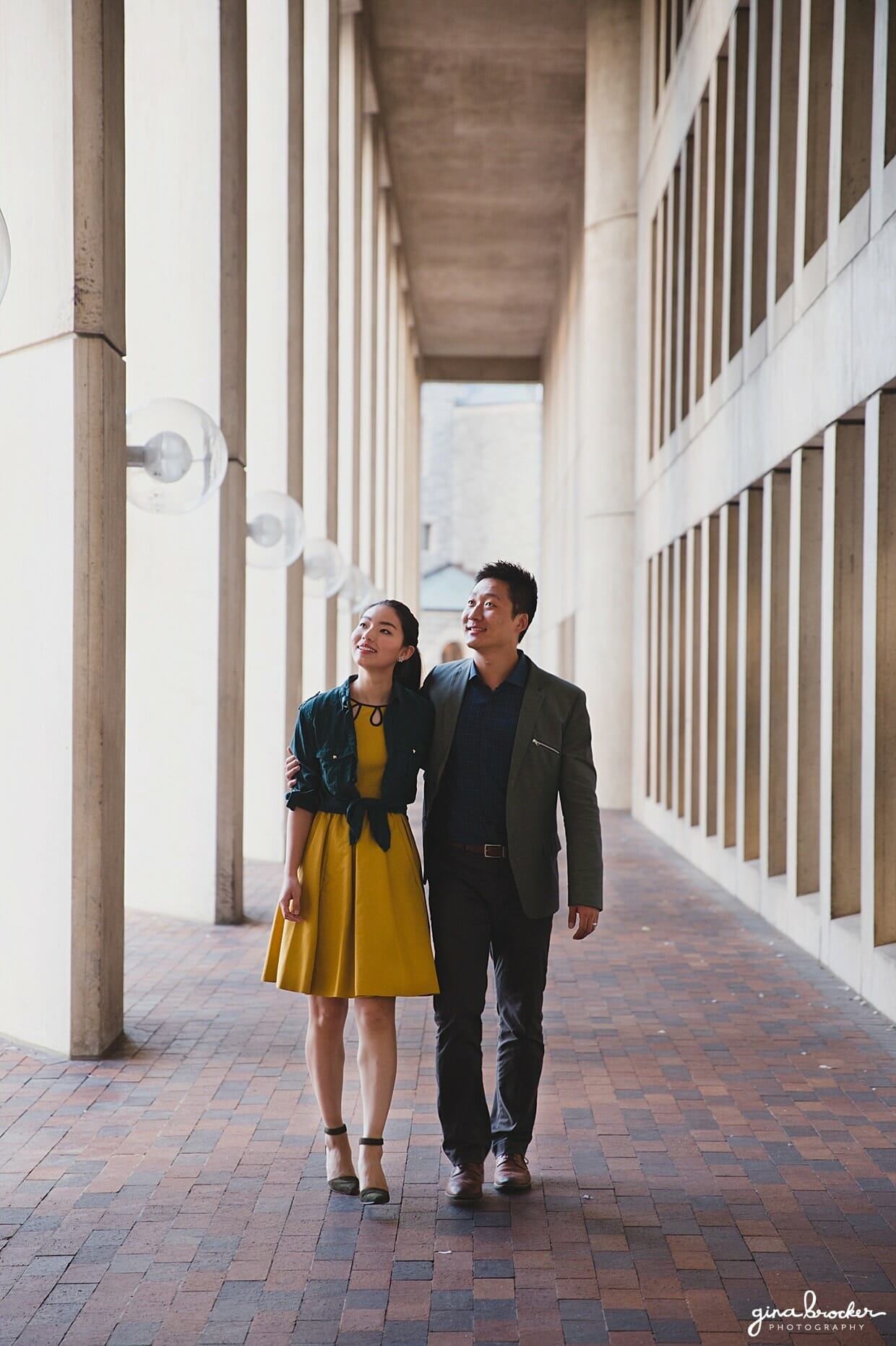 A couple walk together during their Boston engagement session at the Christian Science Center