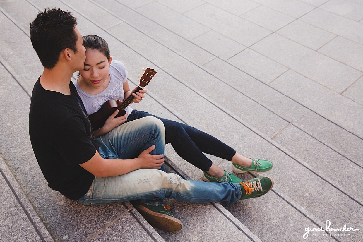 An aerial view of a couple playing an ukulele during their engagement at the Boston Museum of Fine Art