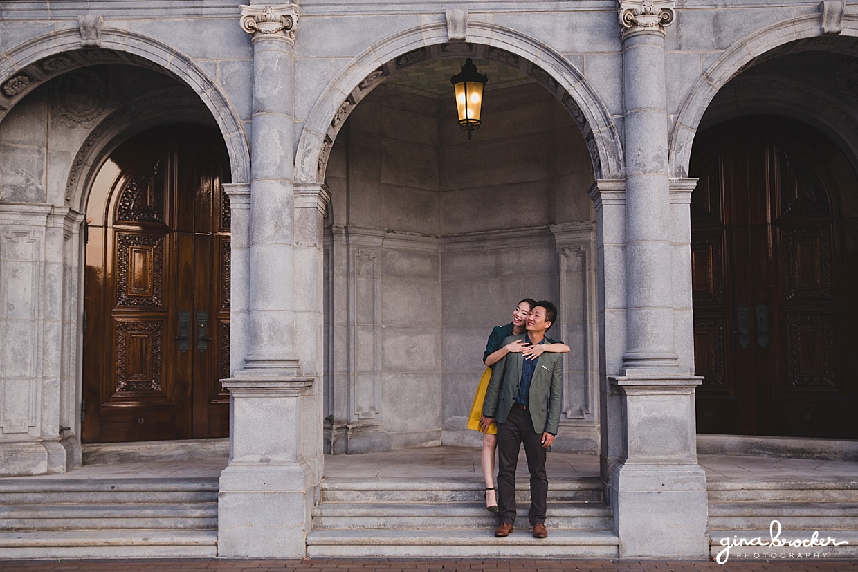 A sweet portrait of a couple holding hugging each other on the steps of the Christian Science Center during their Boston Engagement Session