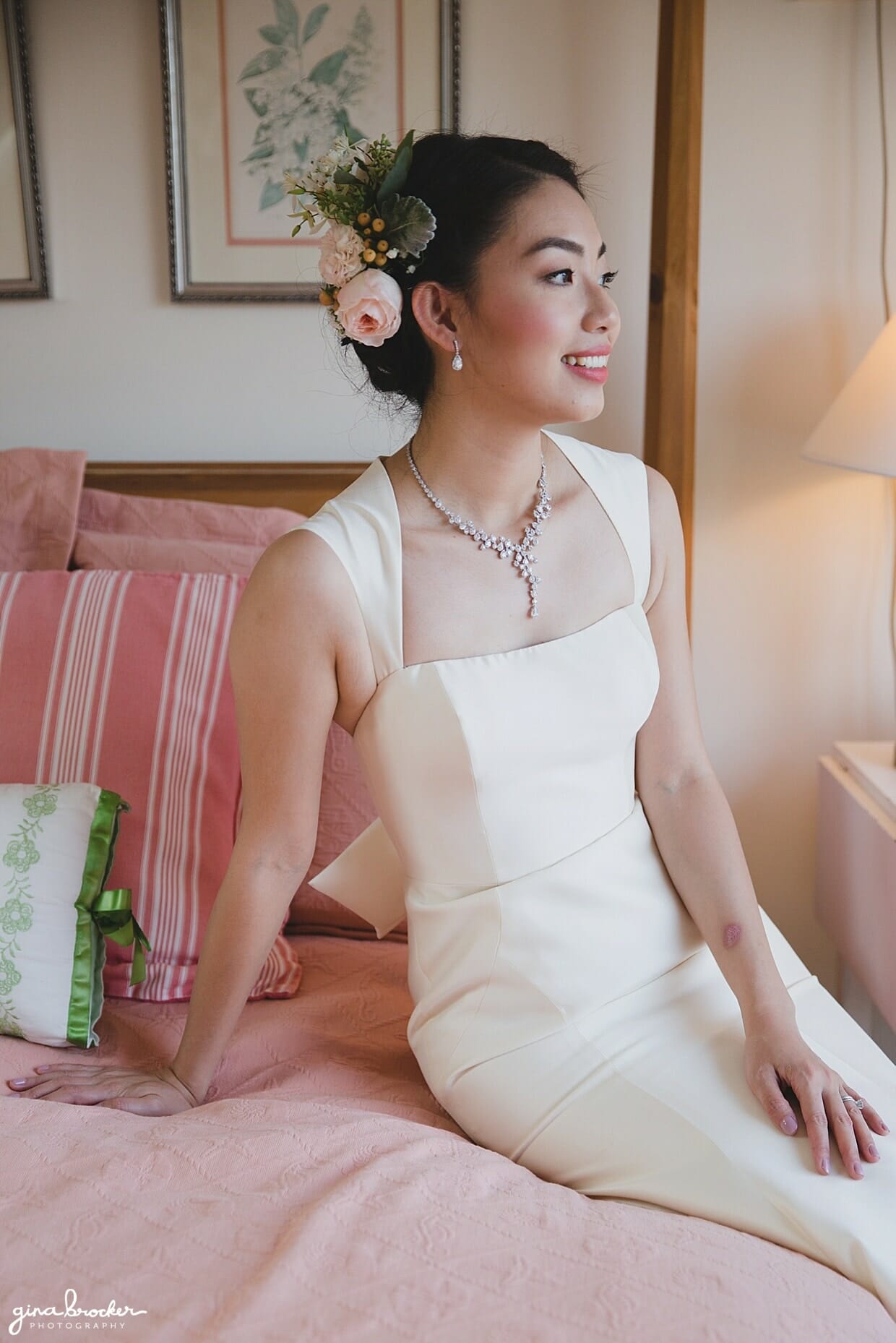 A portrait of a bride wearing an Amsale dress and floral hairpiece on the morning of her wedding in gloucester, massachusetts