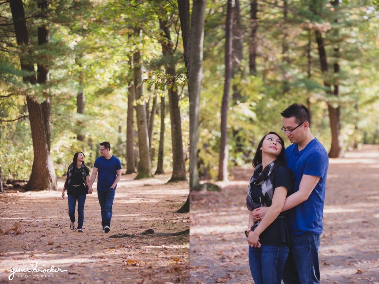 A couple walk through the Boston woods during their fall engagement