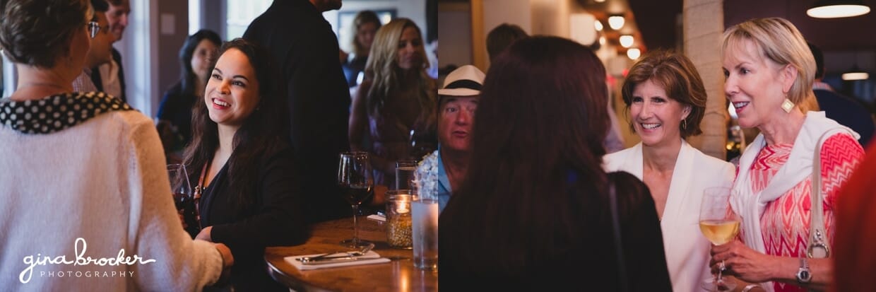 Photojournalist photographs of guest talking during a wedding rehearsal dinner at Backyard BBQ restaurant in Nantucket, Massachusetts