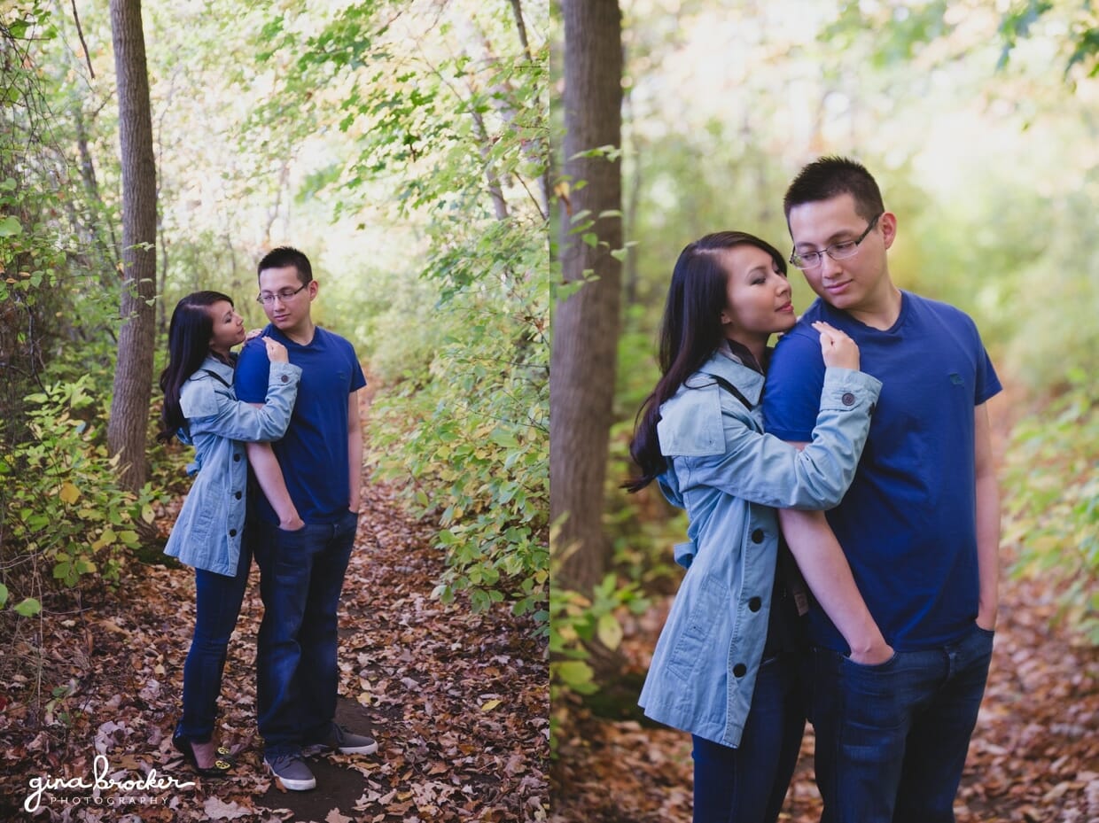 A sweet portrait of a couple hug in the woods during their fall engagement session in boston