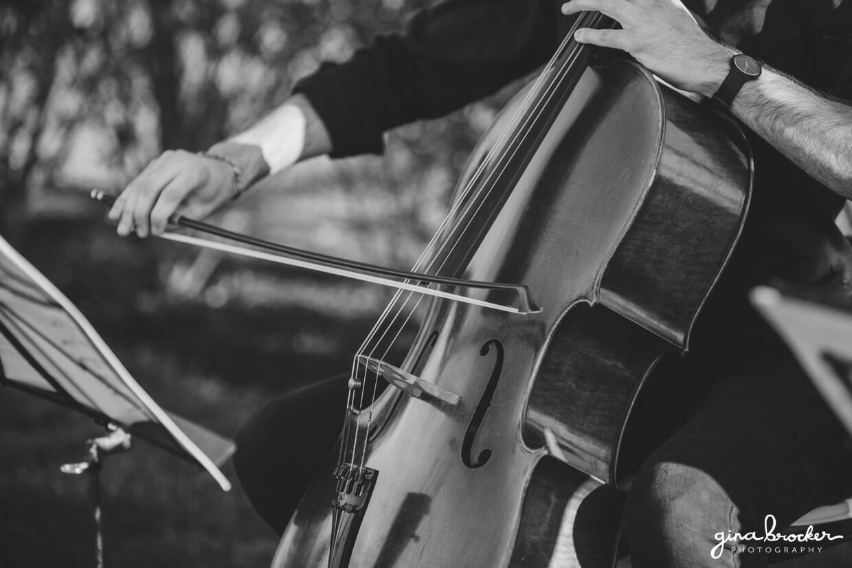 A detailed photograph of a musician playing the cello during a Nantucket wedding at the Westmoor Club