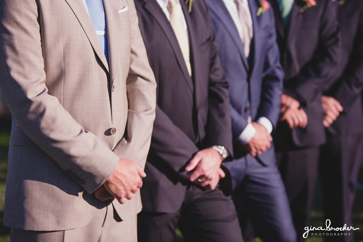 A detailed photograph of the groom and groomsmen standing at the top of the aisle before the ceremony at Westmoor Club in Nantucket, Massachusetts