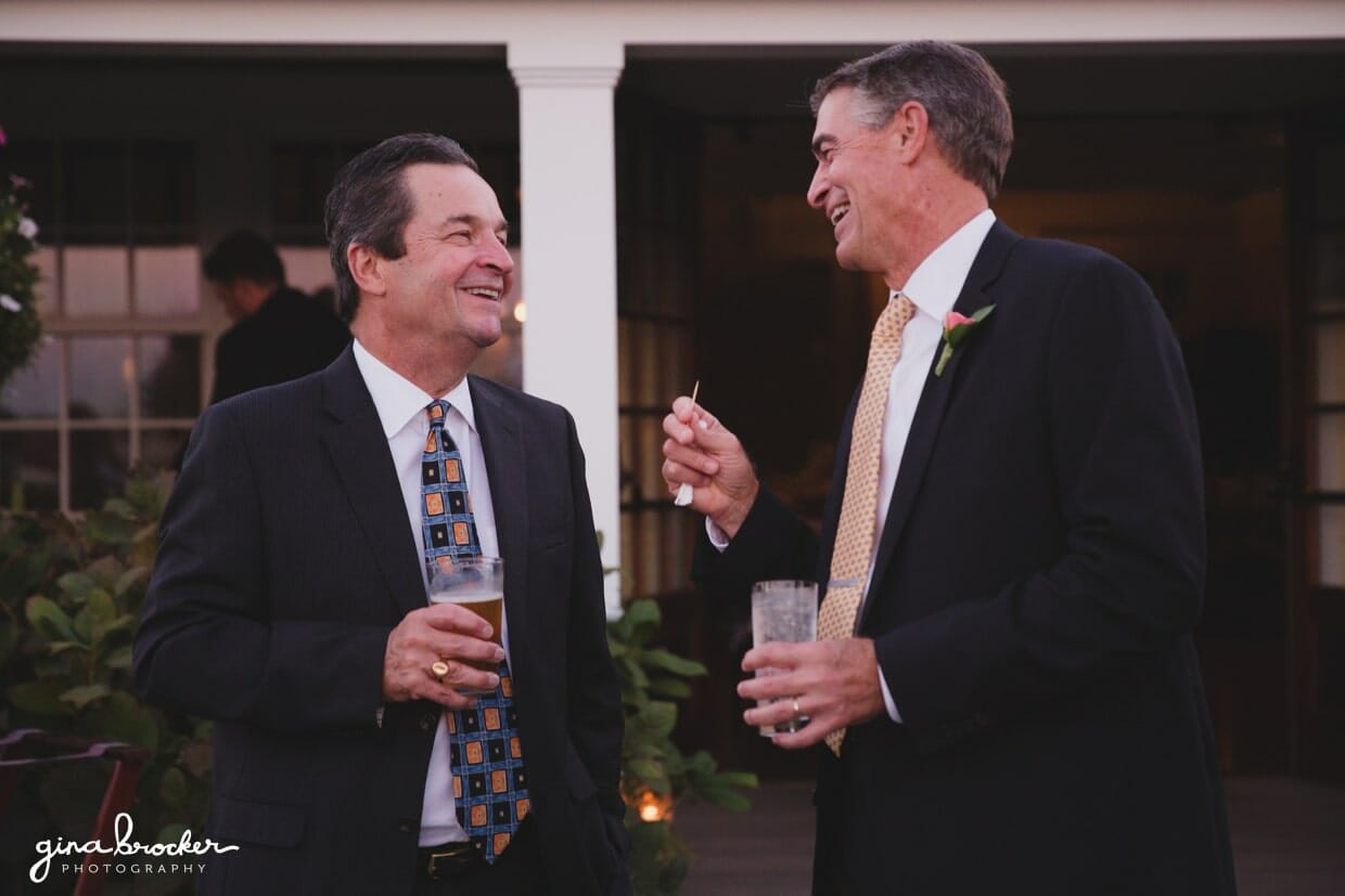 A candid photograph of wedding guests talking and laughing during the cocktail hour of Nantucket Wedding in Westmoor Club