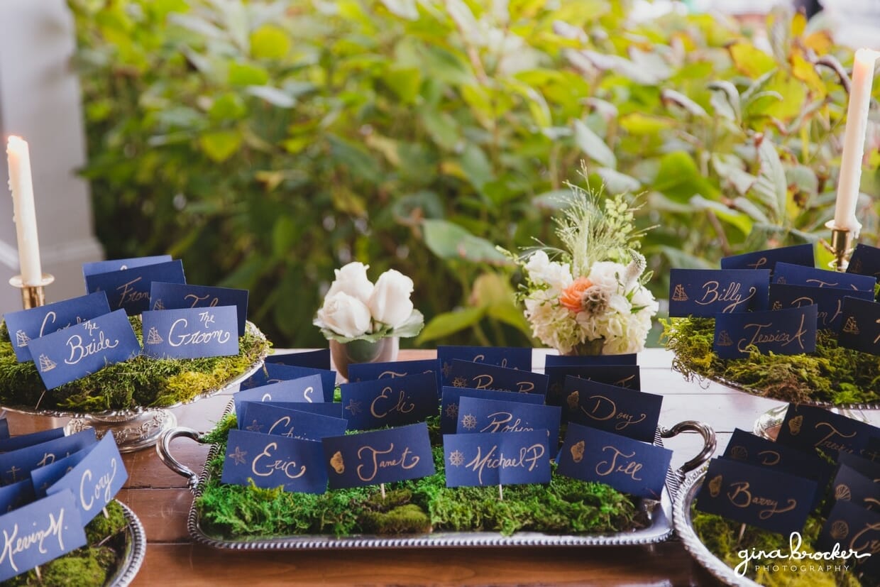 A detailed photograph of nautical and garden inspired escort cards at the Nantucket Wedding in the Westmoor Club