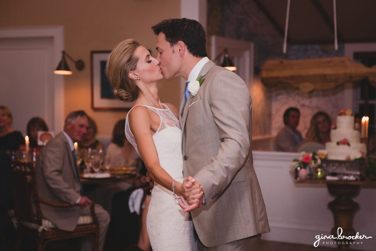 The bride and groom kiss during their first dance as husband and wife at their Westmoor Club wedding in Nantucket, Massachusetts