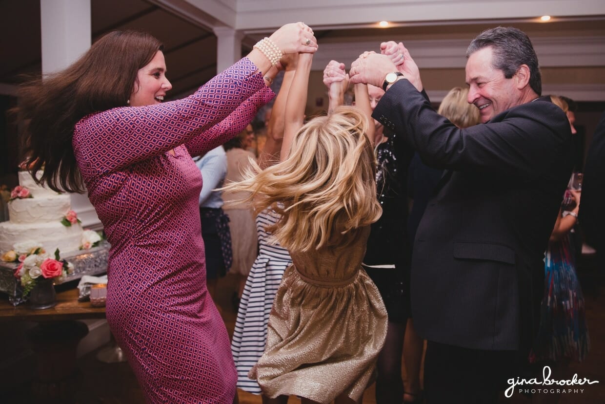A fun photograph of the flower girl and her family dancing at the Westmoor Club during a Nantucket Wedding