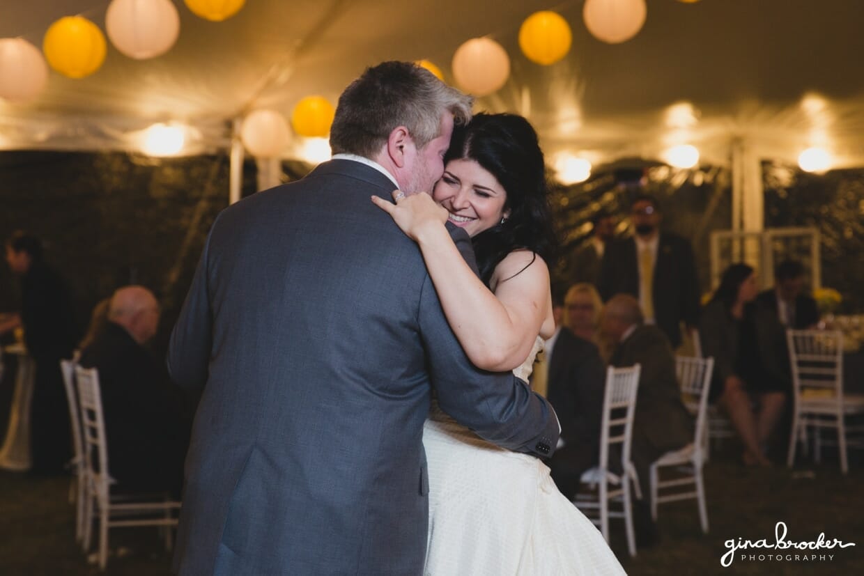 The bride and groom share a sweet first dance as husband and wife during their farm wedding in Oxford, Massachusetts