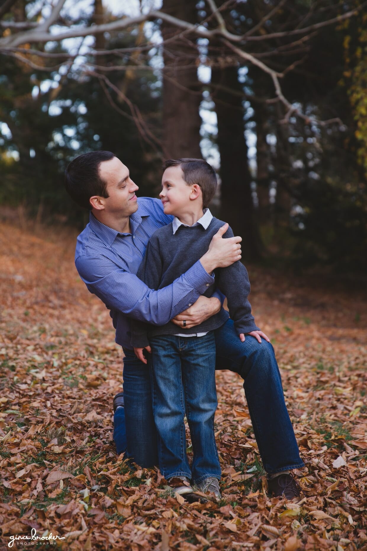 A sweet photograph of a father and son during their fall family photo session in Boston's Arnold Arboretum 