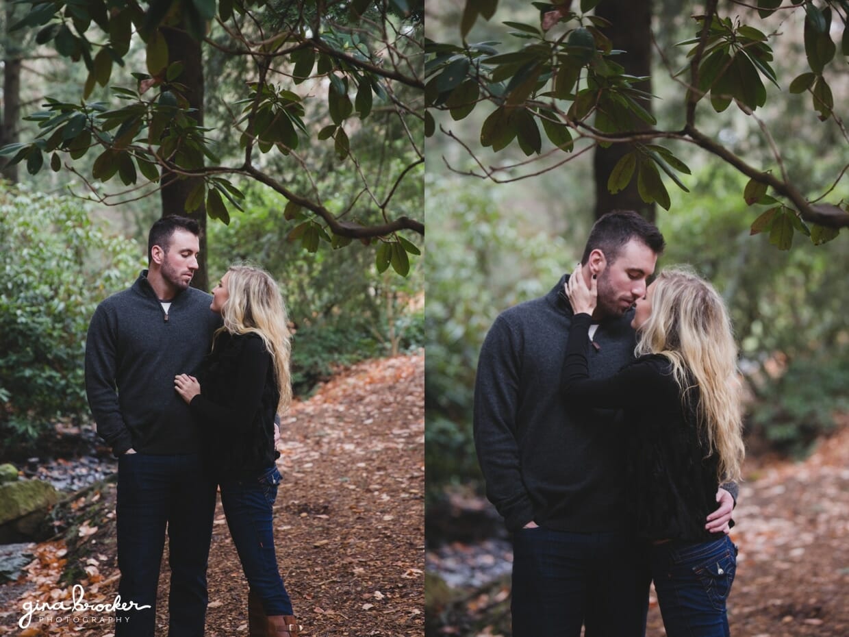 A sweet photograph of couple kissing in the forest during their fall engagement session in Boston's Arnold Arboretum