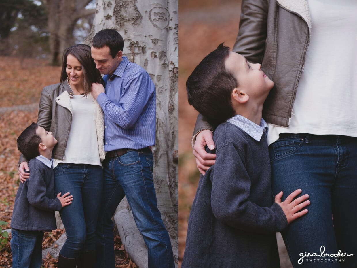 A sweet portrait of a family leaning against a tree during their fall family session in Boston