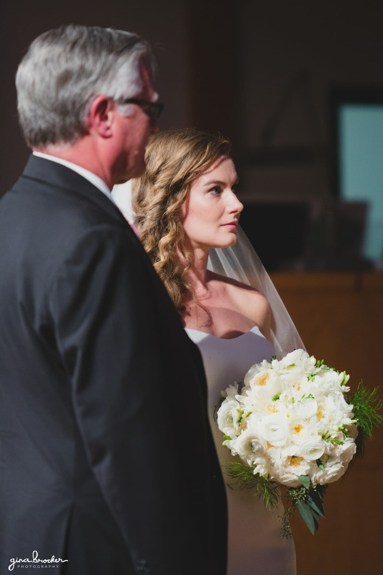 A bride stands next to her father as they approach the top of the aisle during a classic and elegant Boston wedding