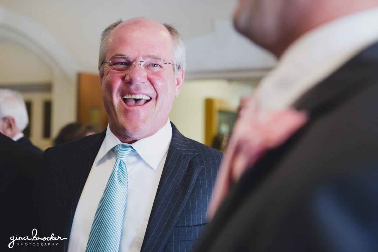 Candid photograph of guests laughing during a elegant and classic Boston wedding